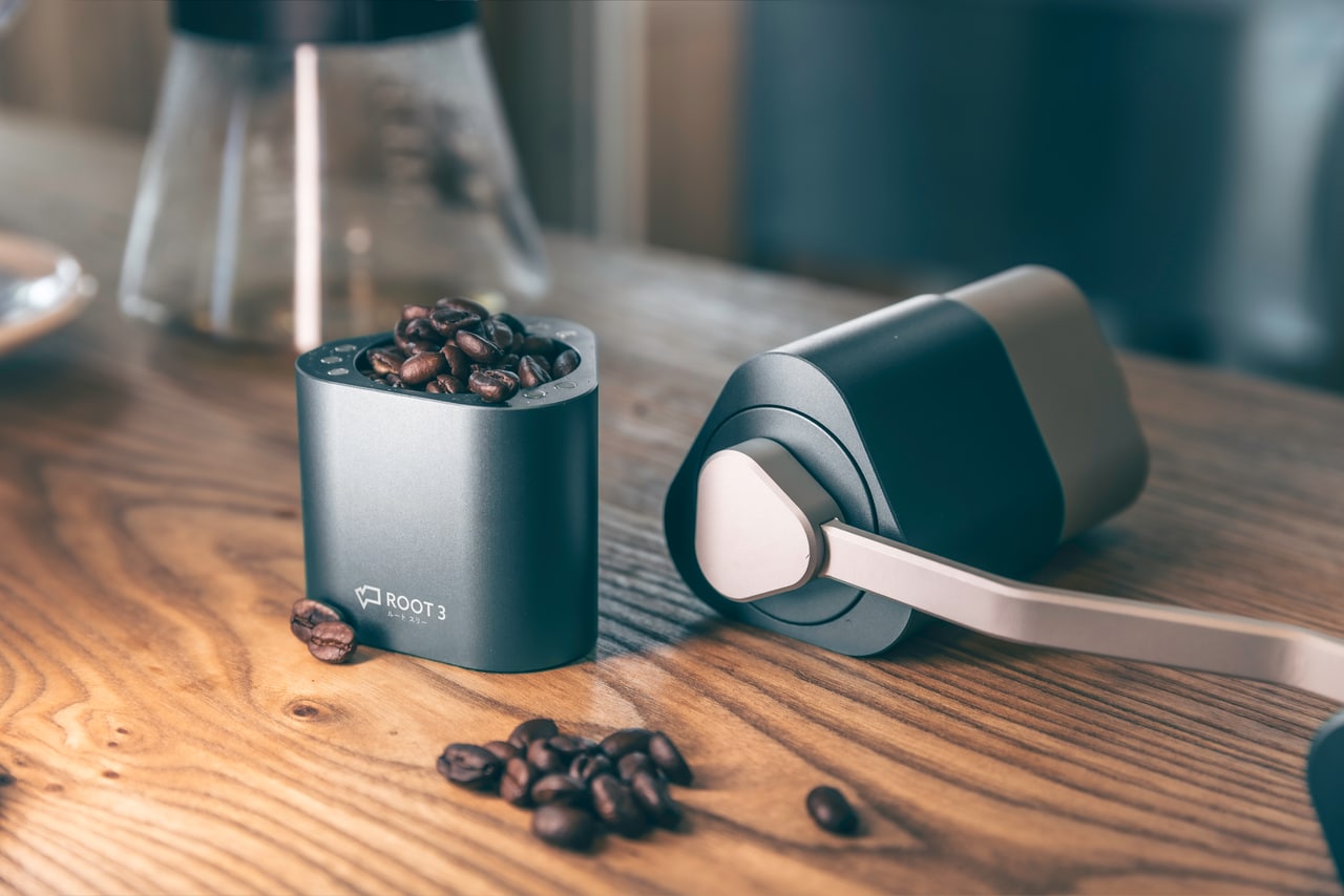 Close-up of the ROOT3 grinder components and coffee beans